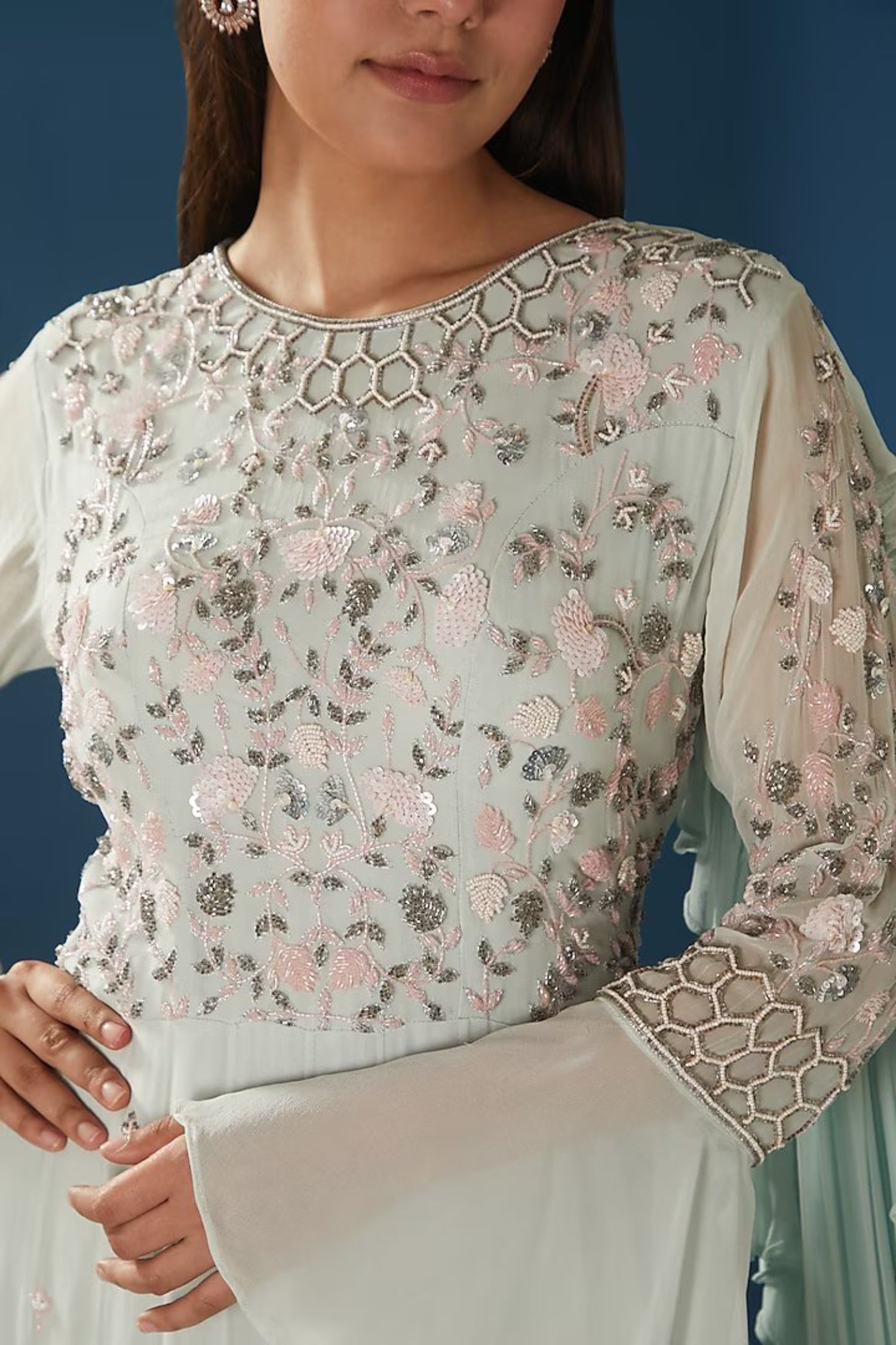 Ice-Blue Tired Gown With Bell Sleeves.