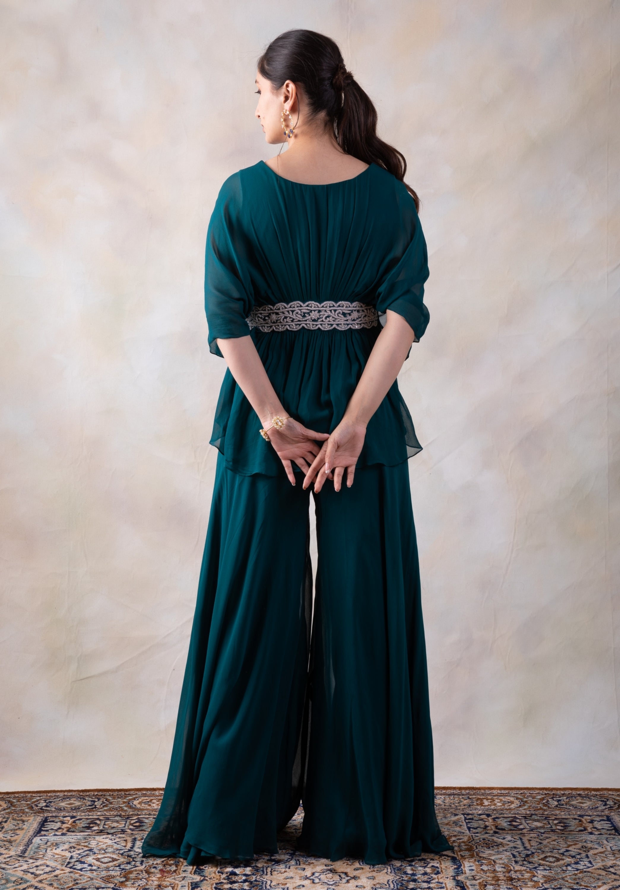Rama Green Peplum Top With Hand Embroidery On The Waist Paired With A Sharara.