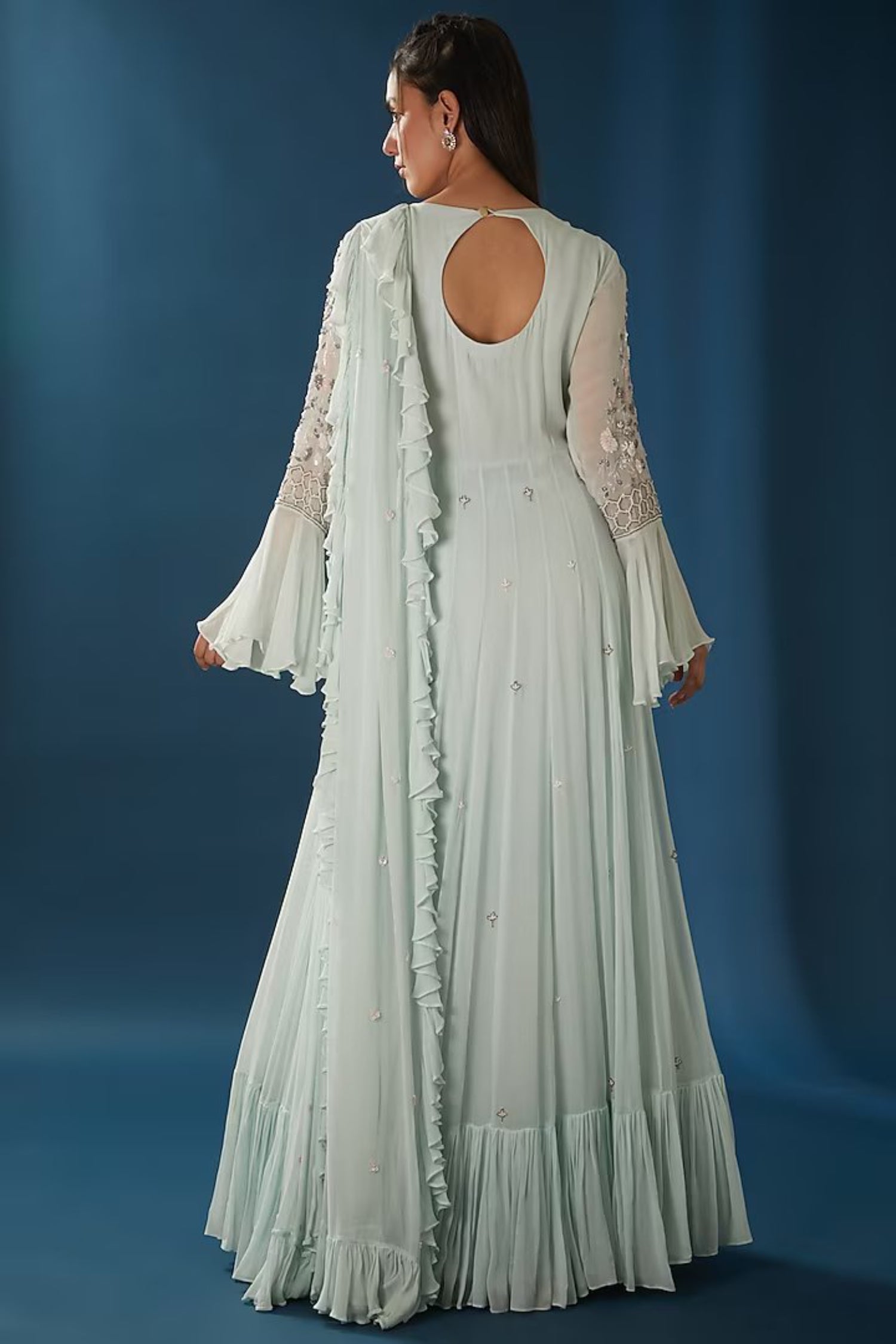 Ice-Blue Tired Gown With Bell Sleeves.