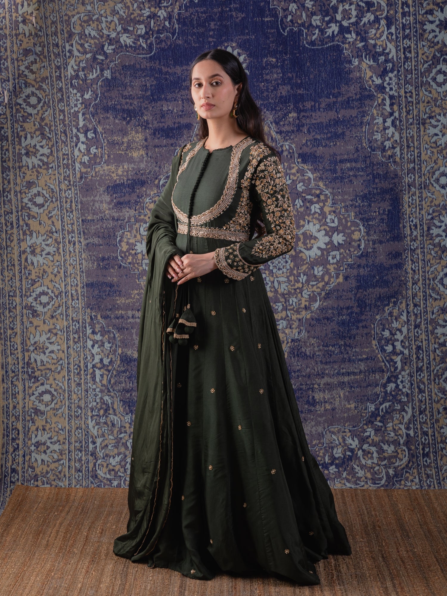 Mehendi Green Anarkali With Heavily Embroidered
Yoke And Sleeves With A Dupatta.