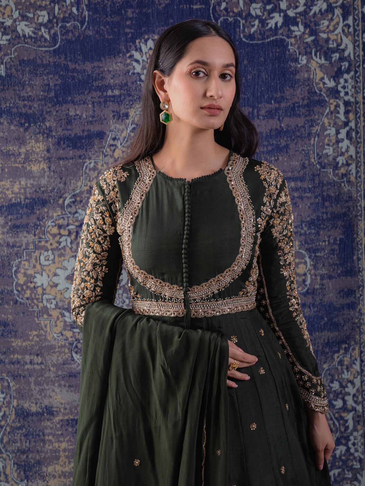 Mehendi Green Anarkali With Heavily Embroidered
Yoke And Sleeves With A Dupatta.