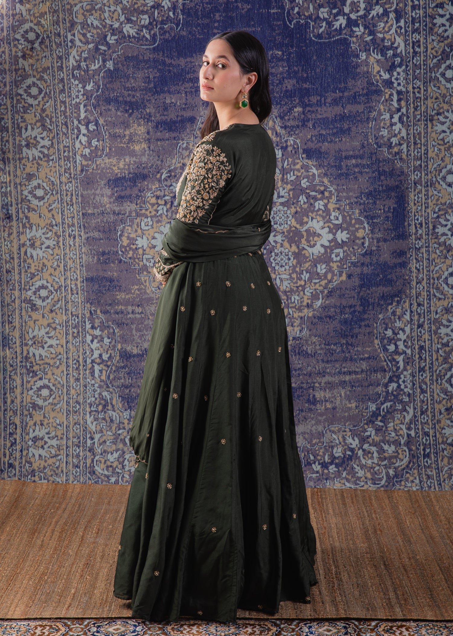 Mehendi Green Anarkali With Heavily Embroidered
Yoke And Sleeves With A Dupatta.