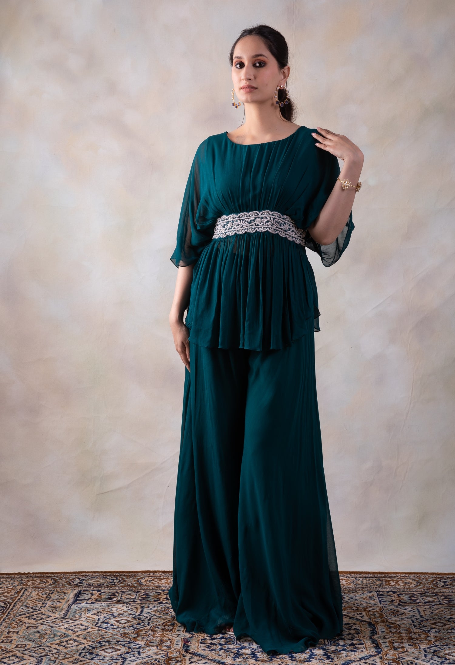 Rama Green Peplum Top With Hand Embroidery On The Waist Paired With A Sharara.